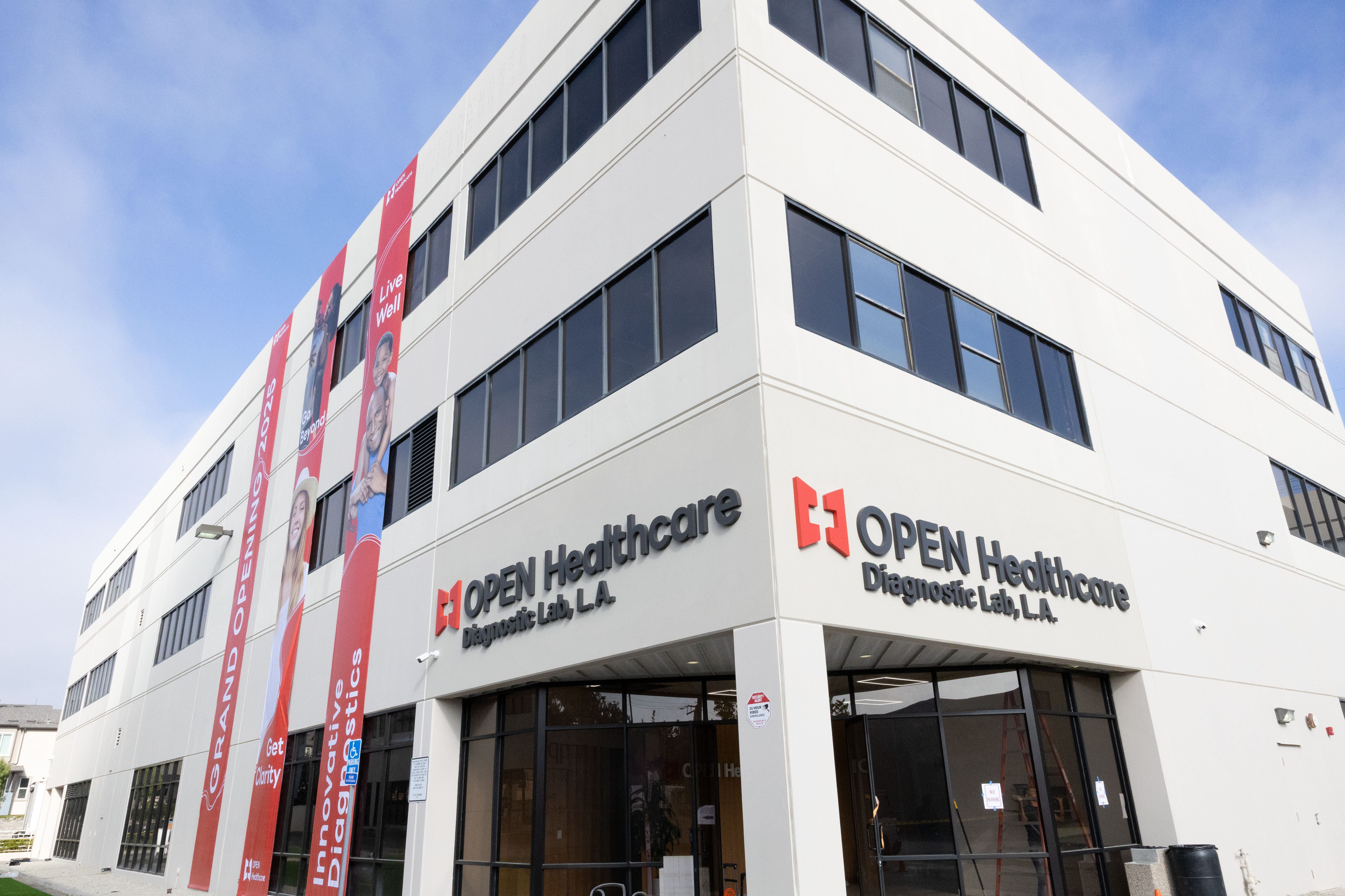 A white building with red and black signs